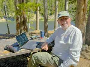 The author uses his portable radio along the banks of the Yellowstone River in Yellowstone National Park. 